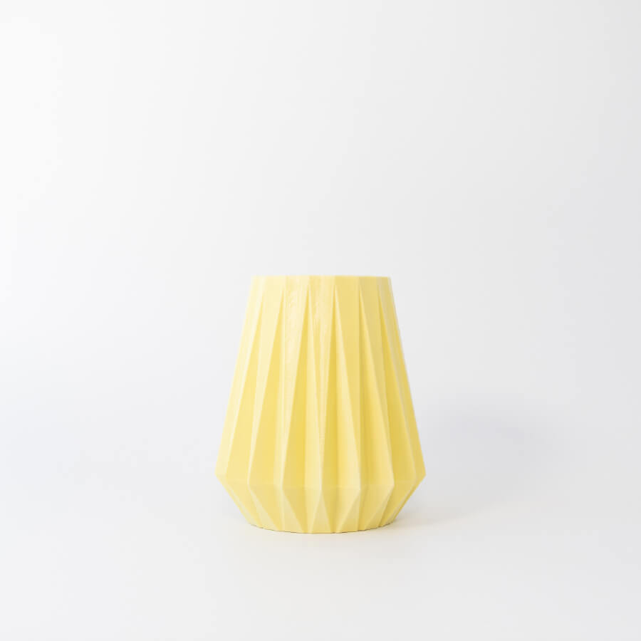 Buddy pet urn. Image of folded origami urn in lemon.